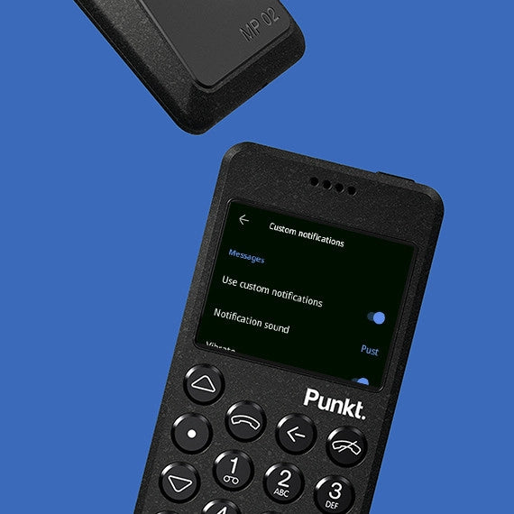 “Black Punkt. phone on blue background showing custom notification settings.”