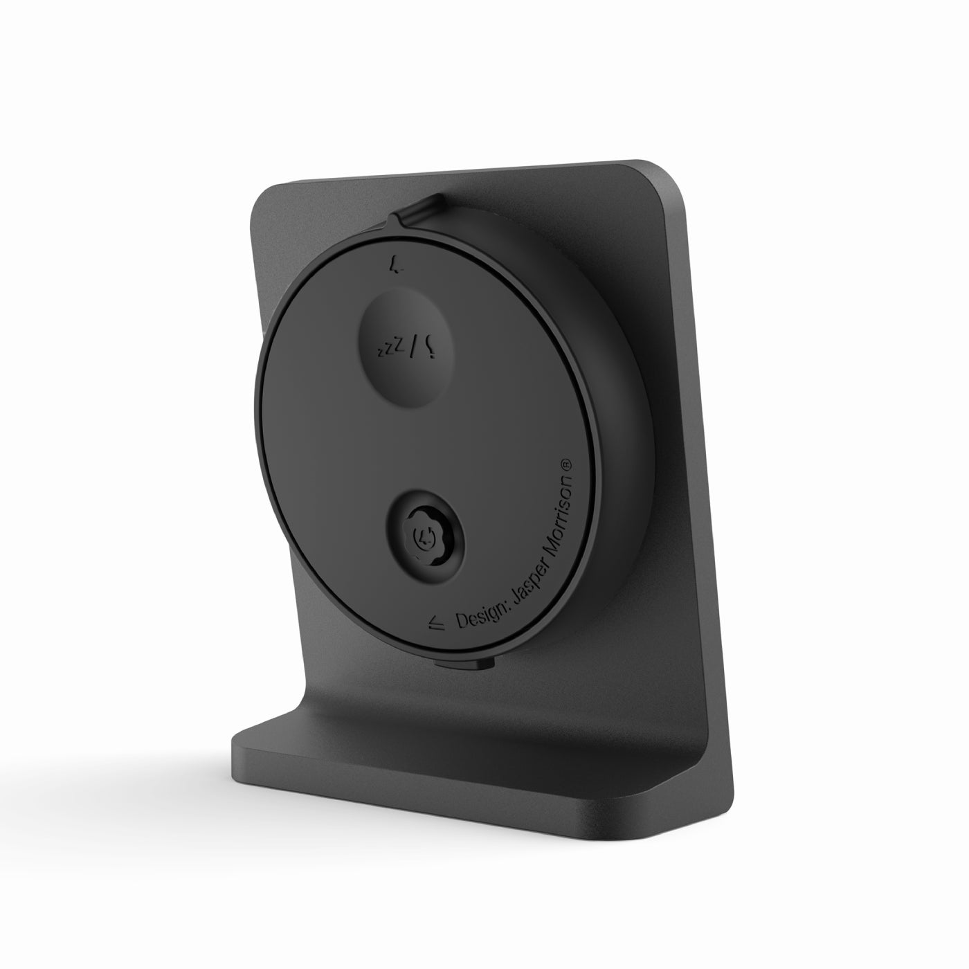 Rear view of the Punkt AC02 alarm clock showing the snooze button and Jasper Morrison design mark.