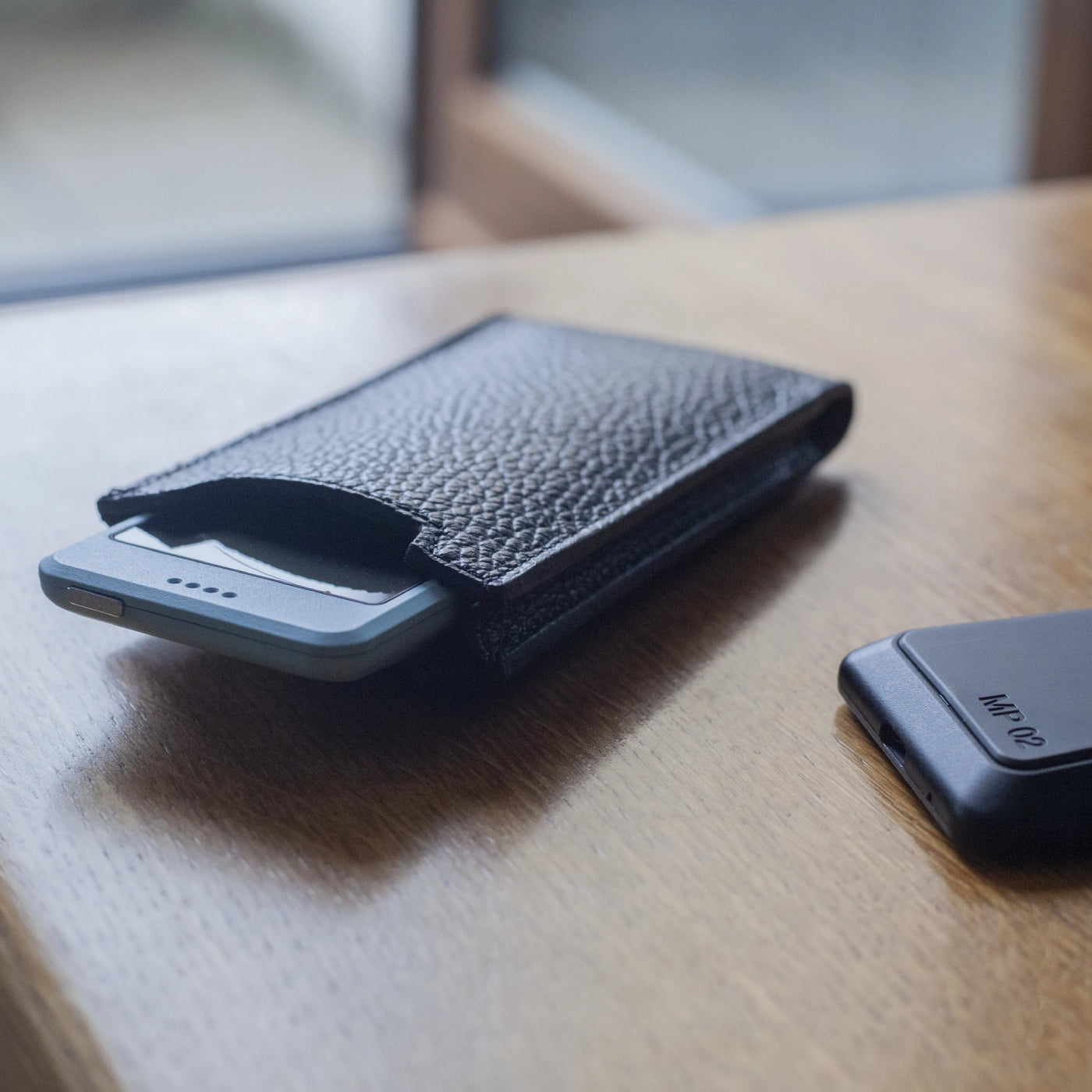 Close-up of blue Punkt. MP02 being pulled out of Danny P. leather case