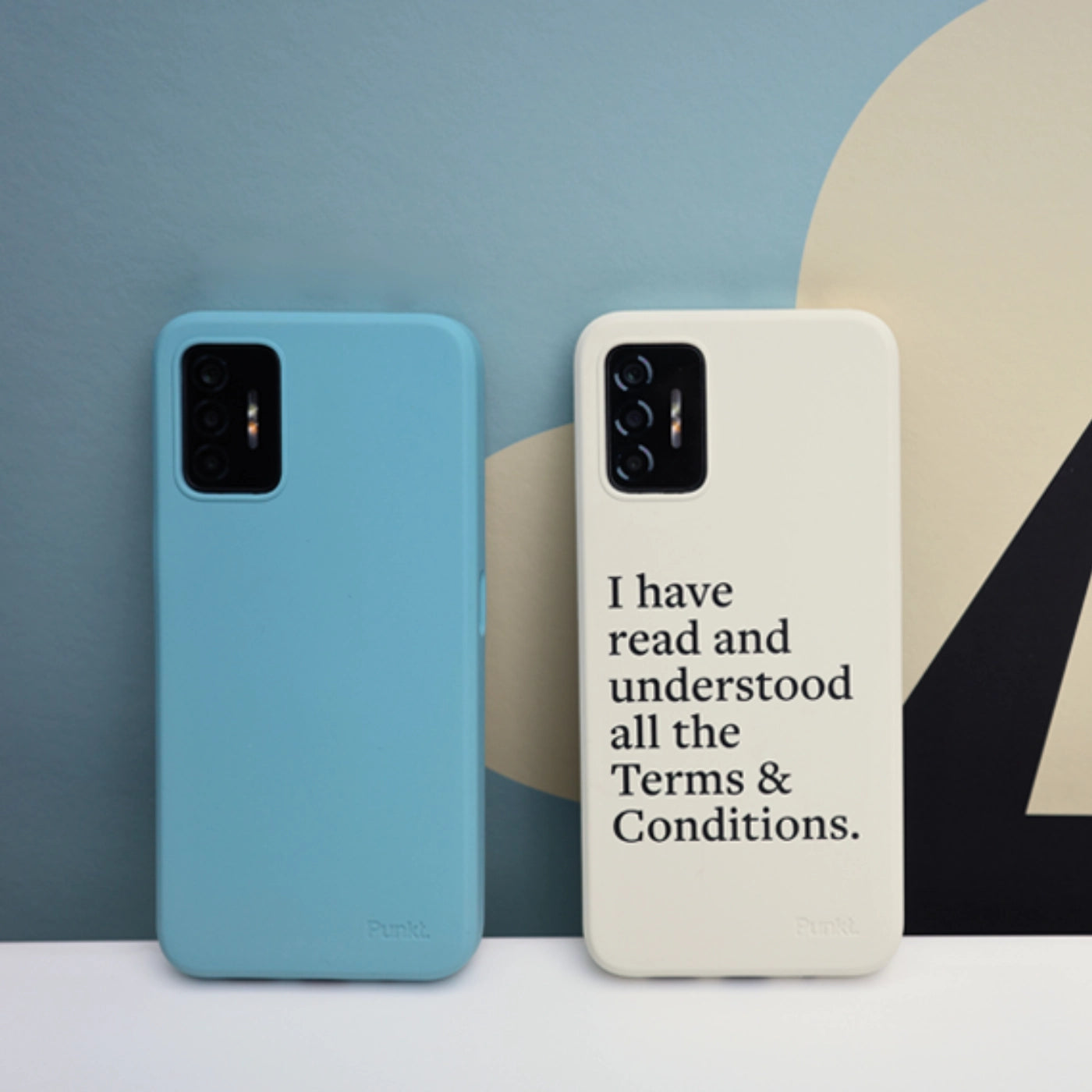 Two Punkt. MC02 smartphones: one in light blue case and one in cream case with printed text "I have read and understood all the Terms & Conditions.