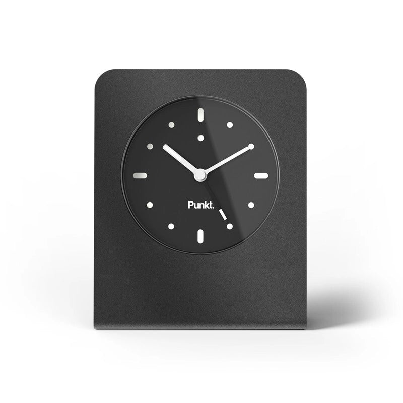 Clock front view – “Front view of black Punkt. desk clock with simple black dial and white markers.”