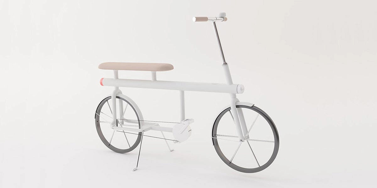 Angled view of the white urban mobility bike showcasing clean lines, a raised saddle, and cylindrical handlebar grips.