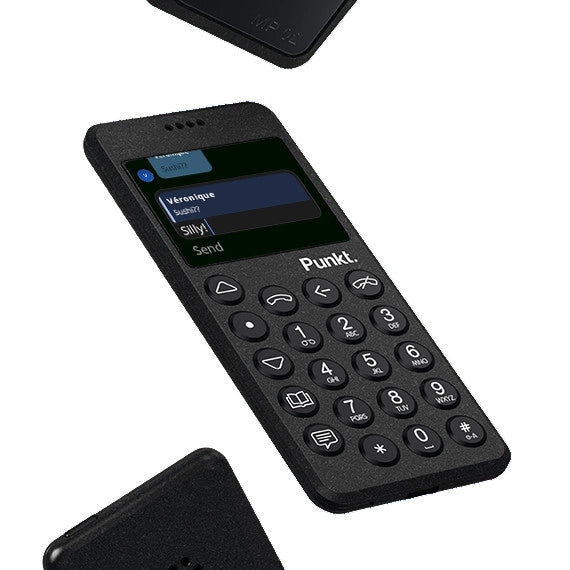 Punkt. MP02 minimalist mobile phone displaying a text message conversation on screen, with physical keypad and black matte finish.