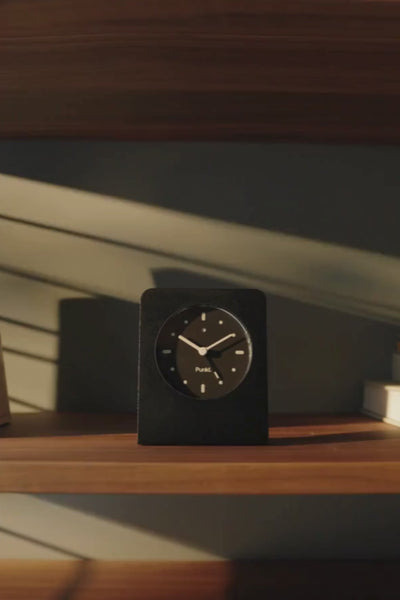 Punkt. AC02 alarm clock ringing, with display flashing and audible alarm sound playing in a minimalist environment.