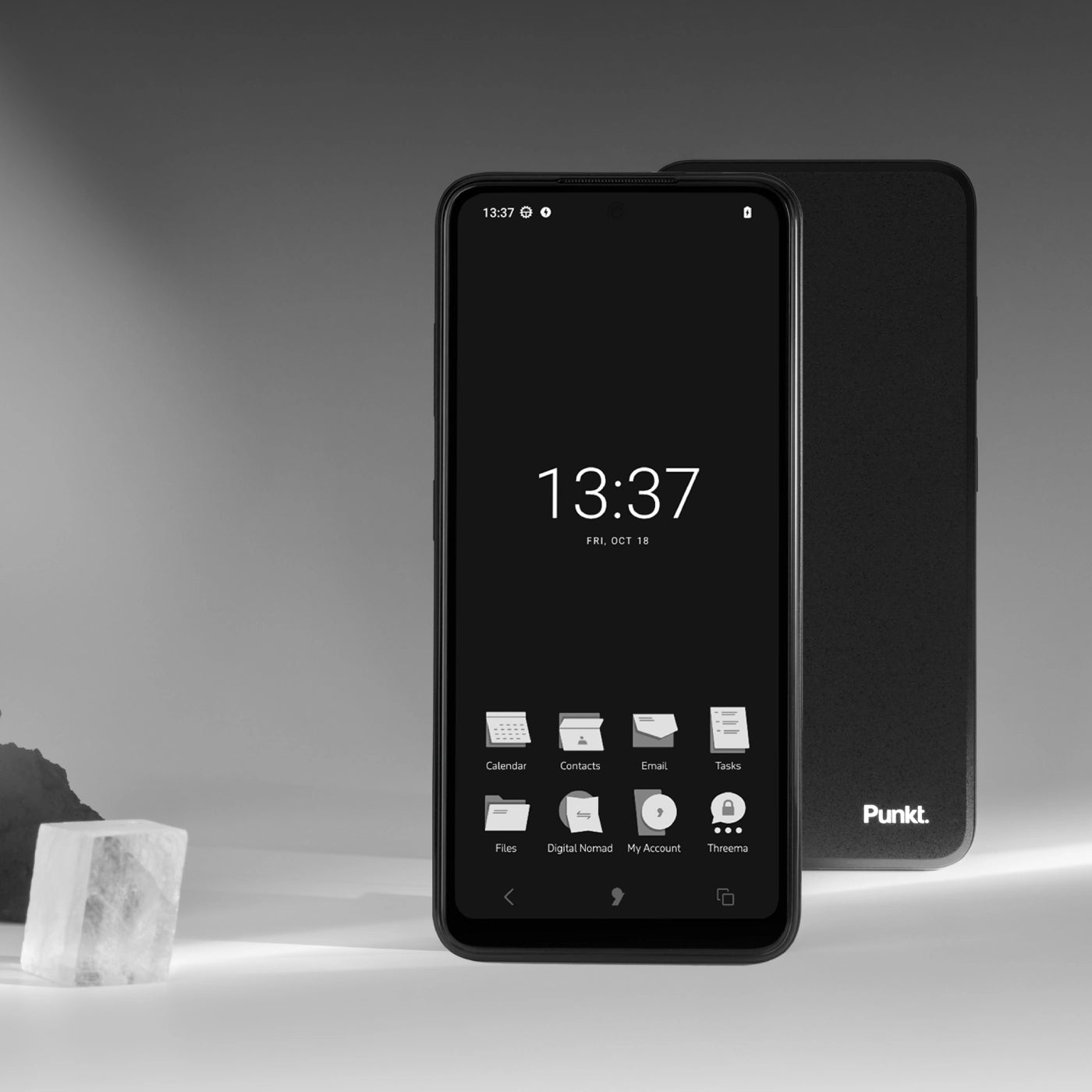 Black and white smartphone showing home screen with time 13:37, app icons, and 'Punkt.' device visible in background.