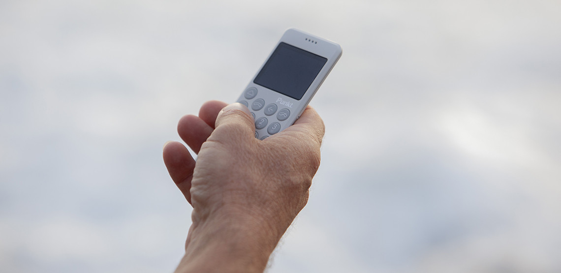 Punkt MP02 Light Grey MP02 mobile phone in the hand near the sea waves